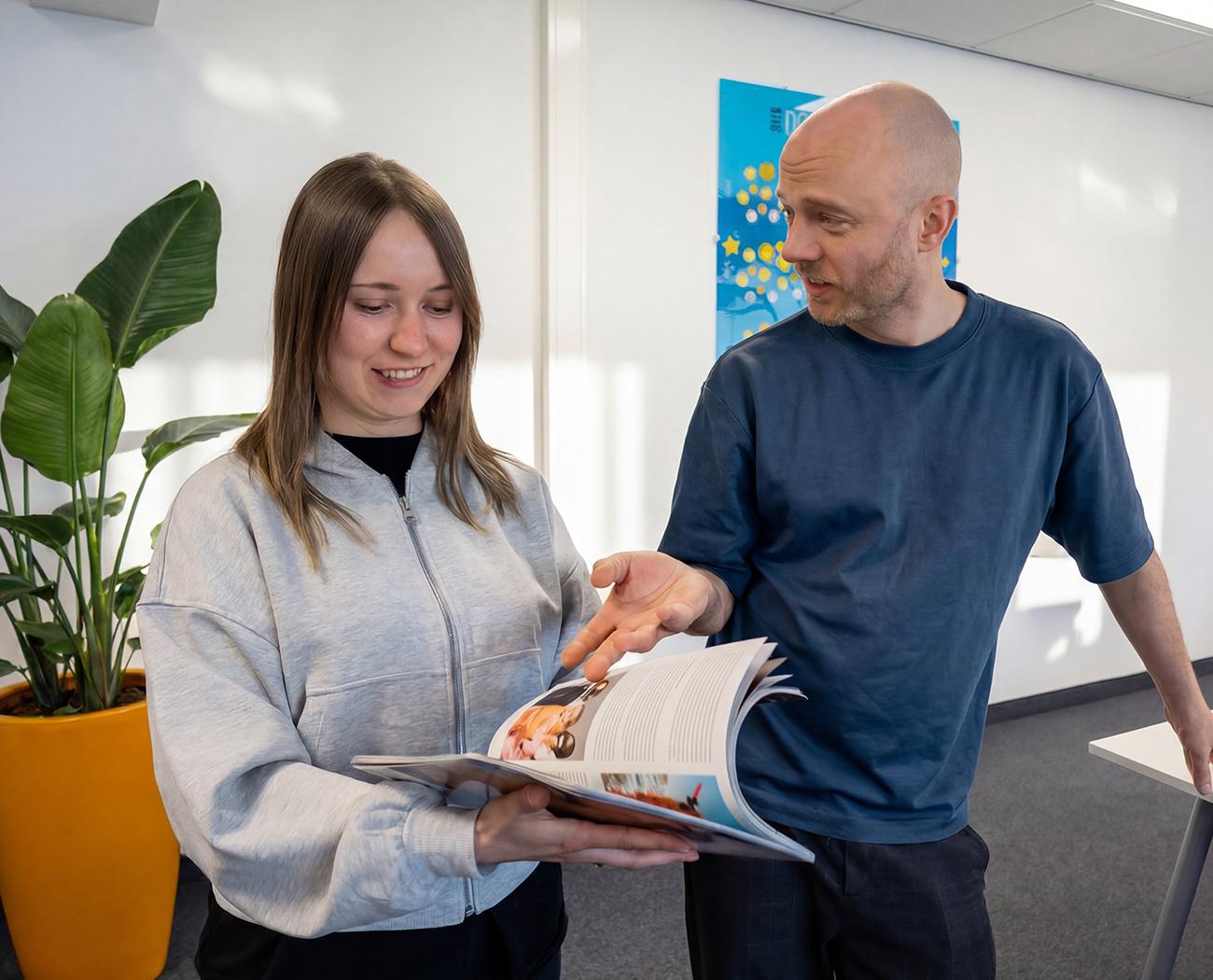 Printed Media | People looking at something in a magazine